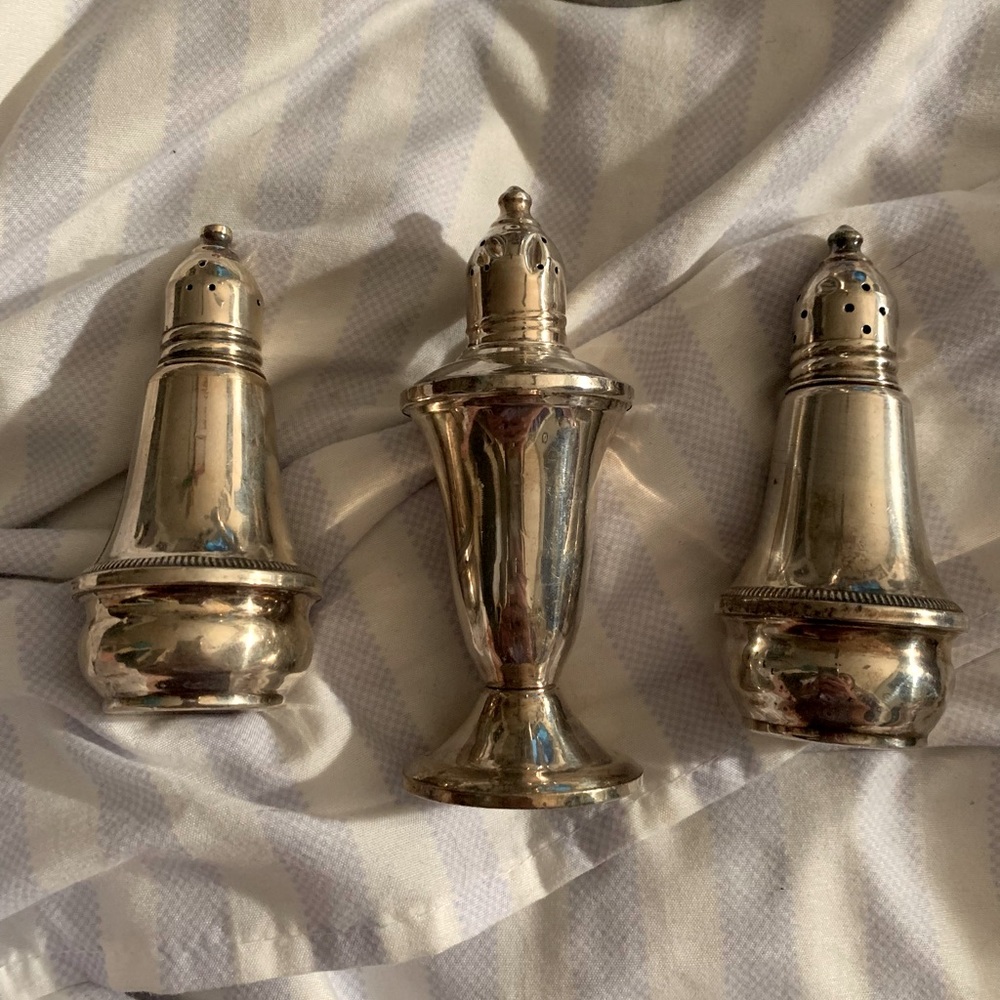 Old antique salt and pepper shakers, and a candle holder